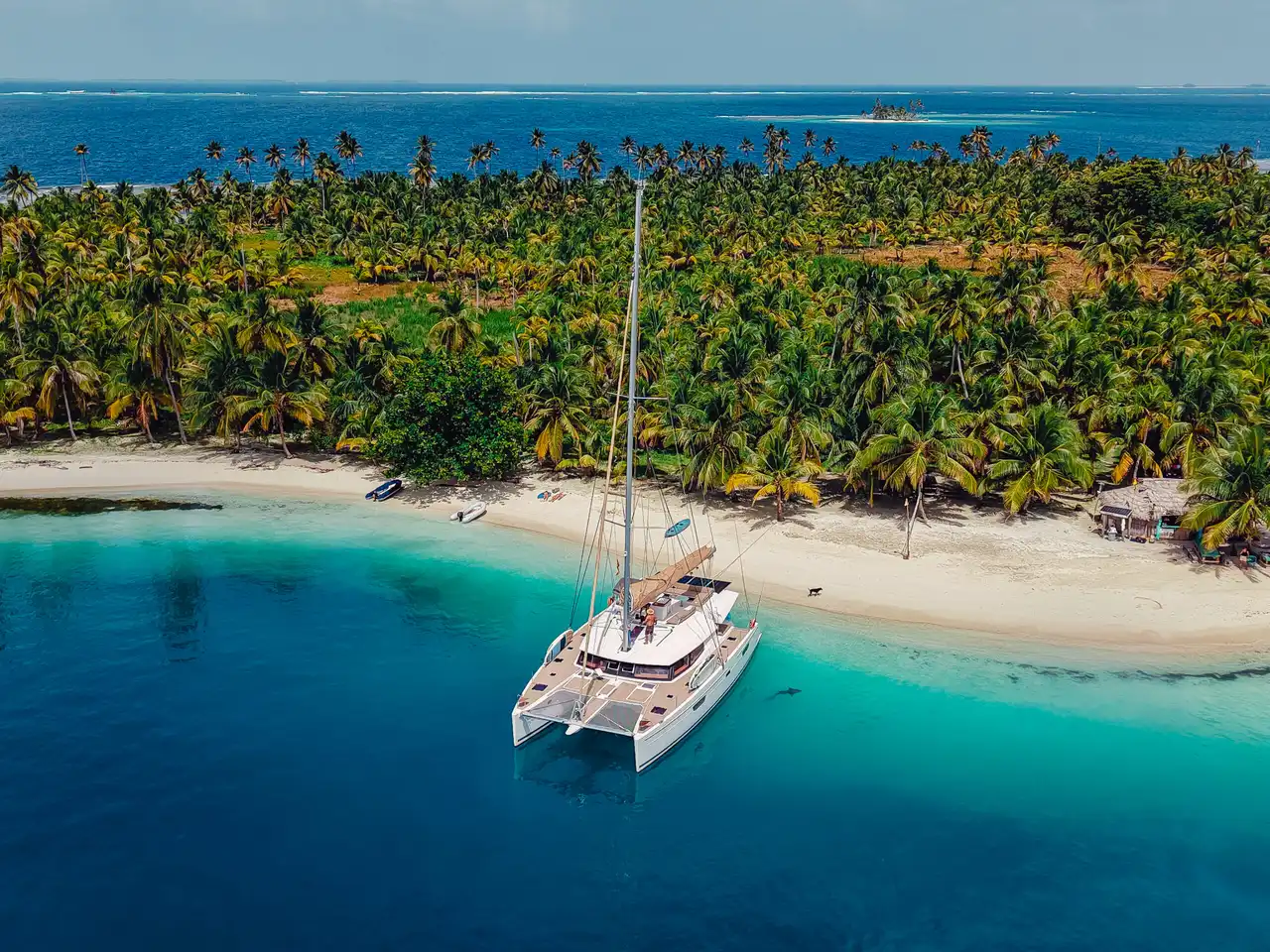 Aerial view of catamaran sailing in San Blas Islands crystal clear waters