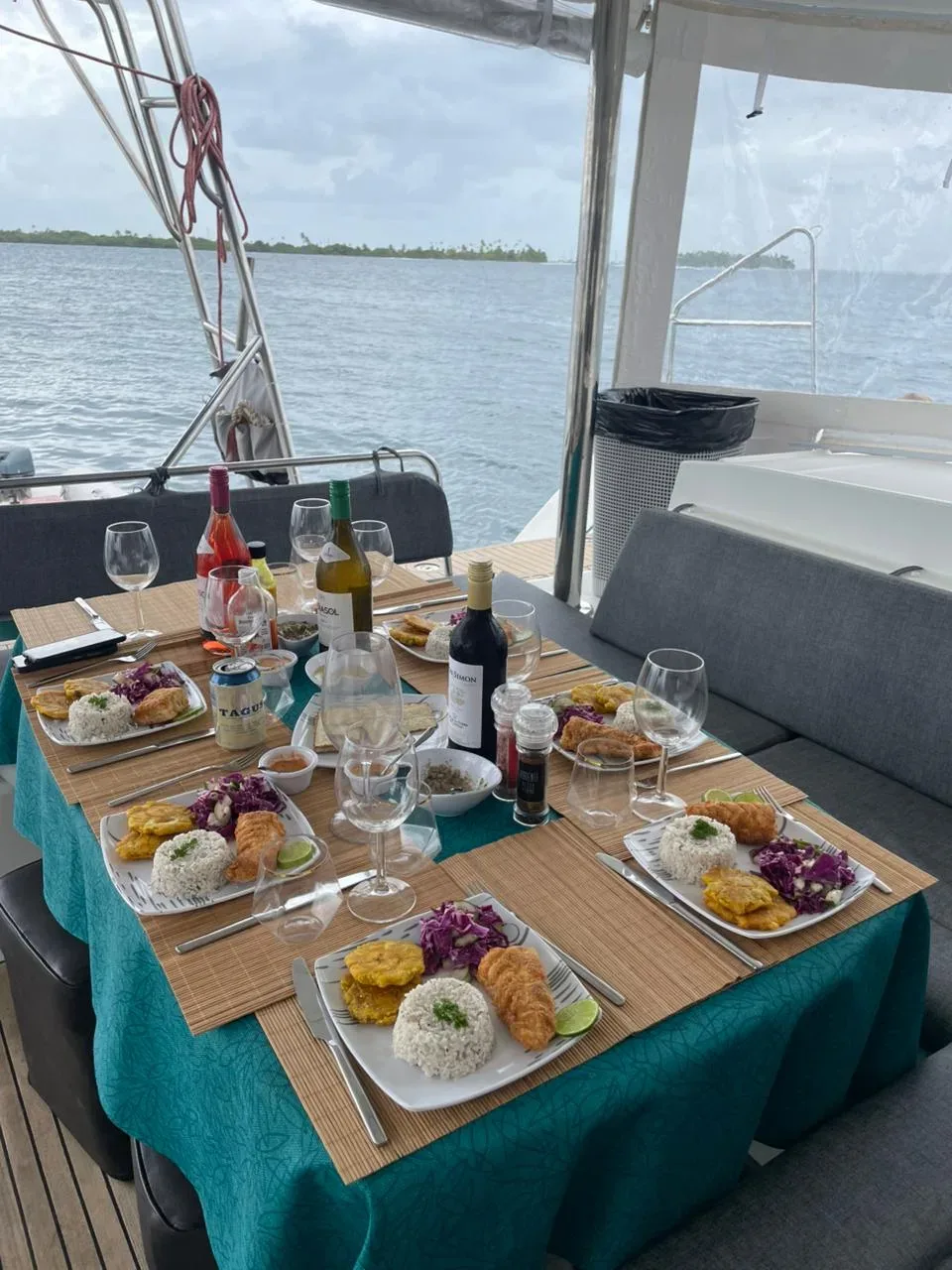 Cockpit table on the Lagoon 450 set with wine, glasses and a full plated dinner