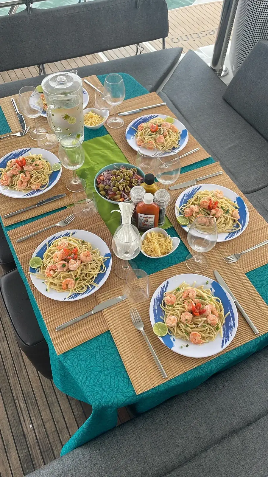 Shrimp pasta for four on the cockpit table of the Lagoon 450