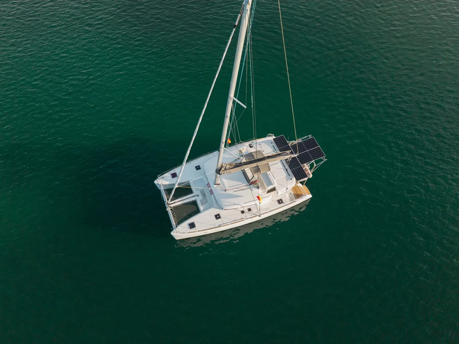 Aerial view straight down onto the Lagoon 450 on deep green water in Guna Yala