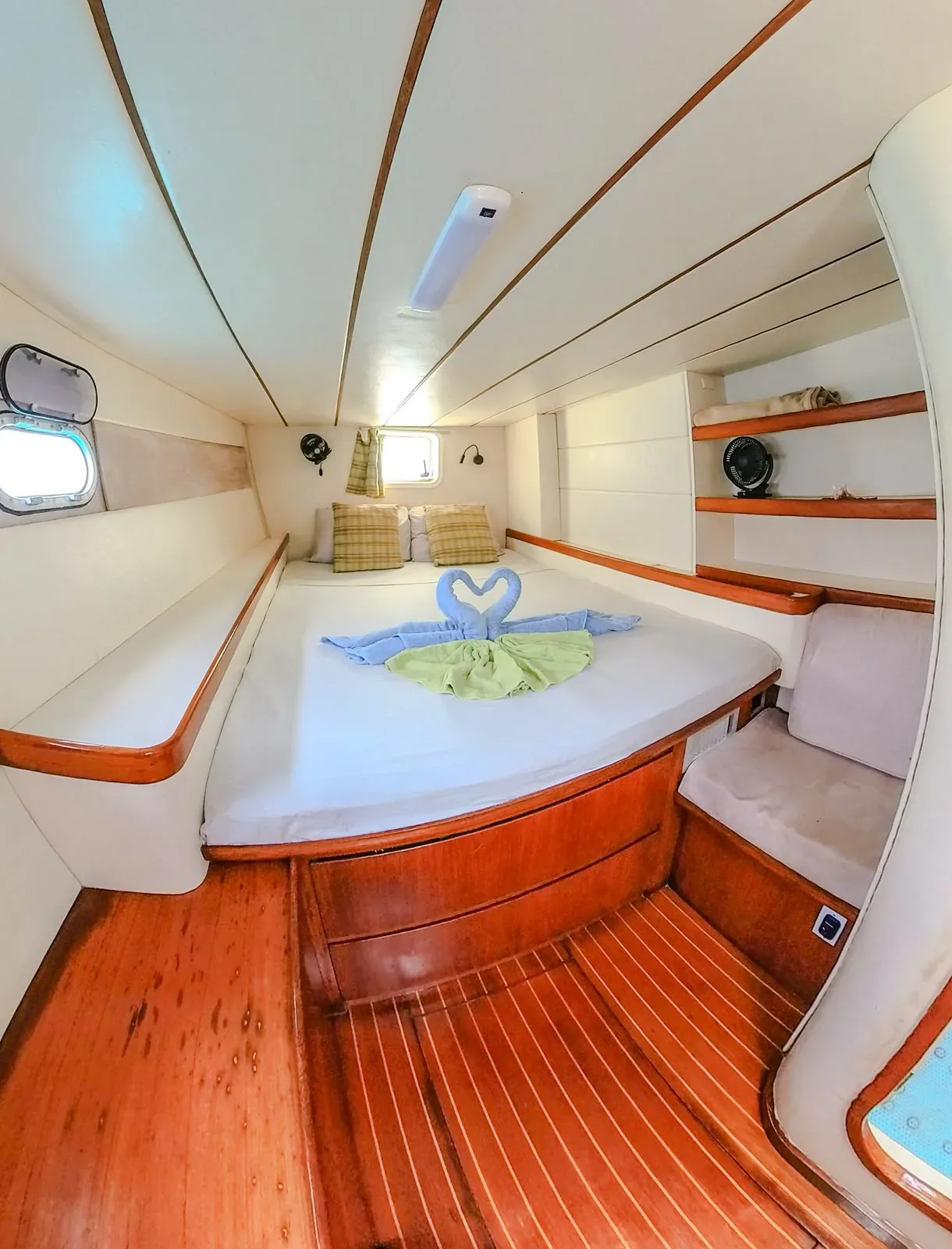 Second double cabin aboard the Lagoon 55 with teak sole, cabin fan and shelving