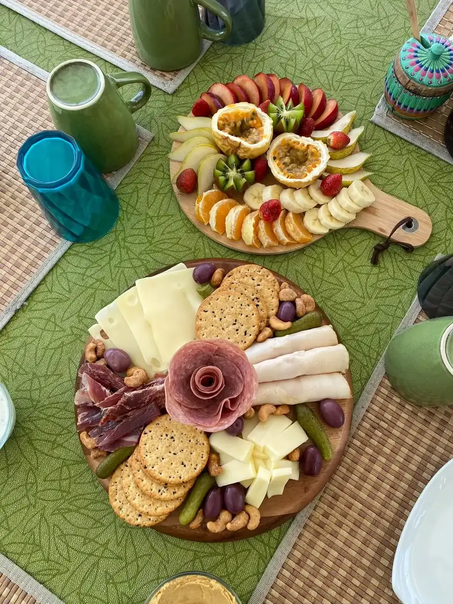 Fruit and charcuterie board with cheese, olives and a green smoothie on the Lagoon 55