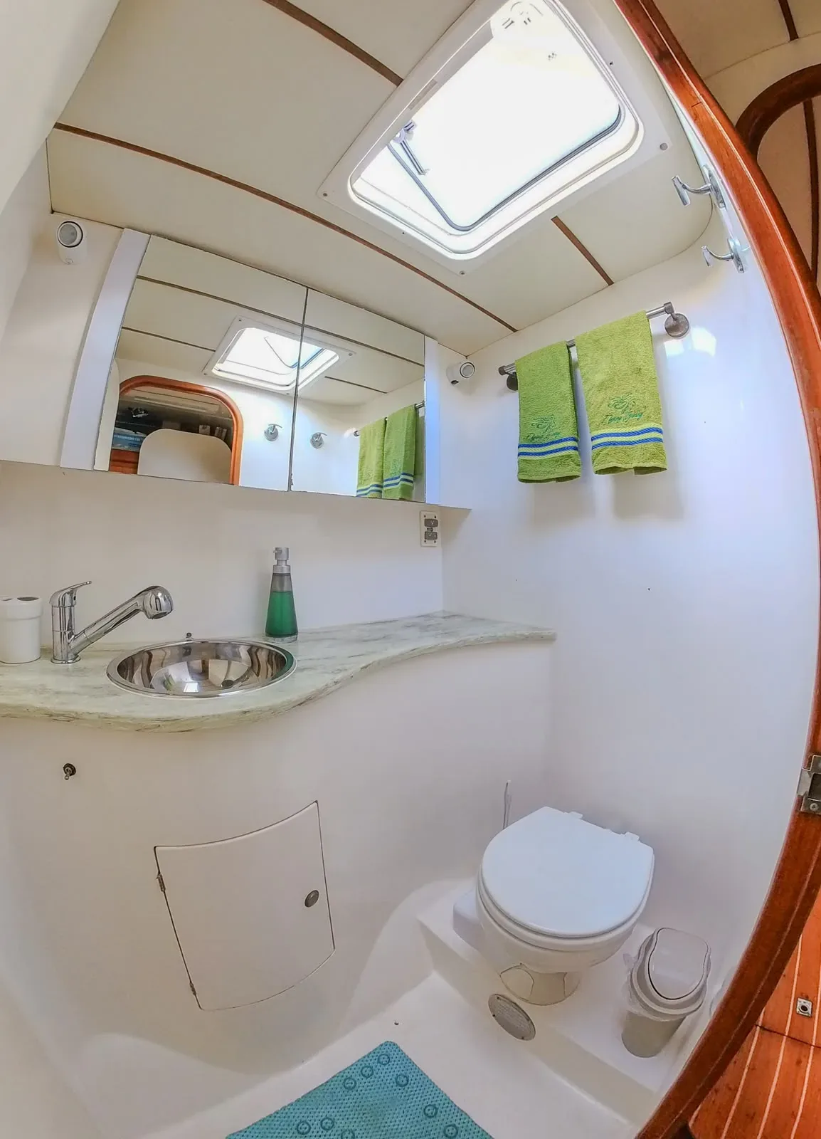 One of the five heads aboard the Lagoon 55, with sink, mirror and overhead hatch