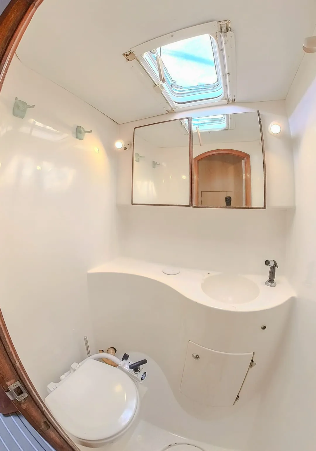 Bathroom with a sink, mirror and deck hatch