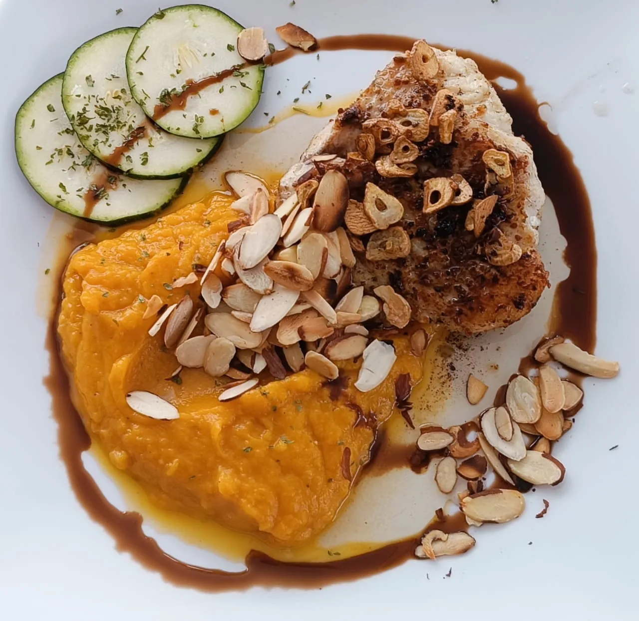 Fish with an orange puree, toasted almonds and zucchini