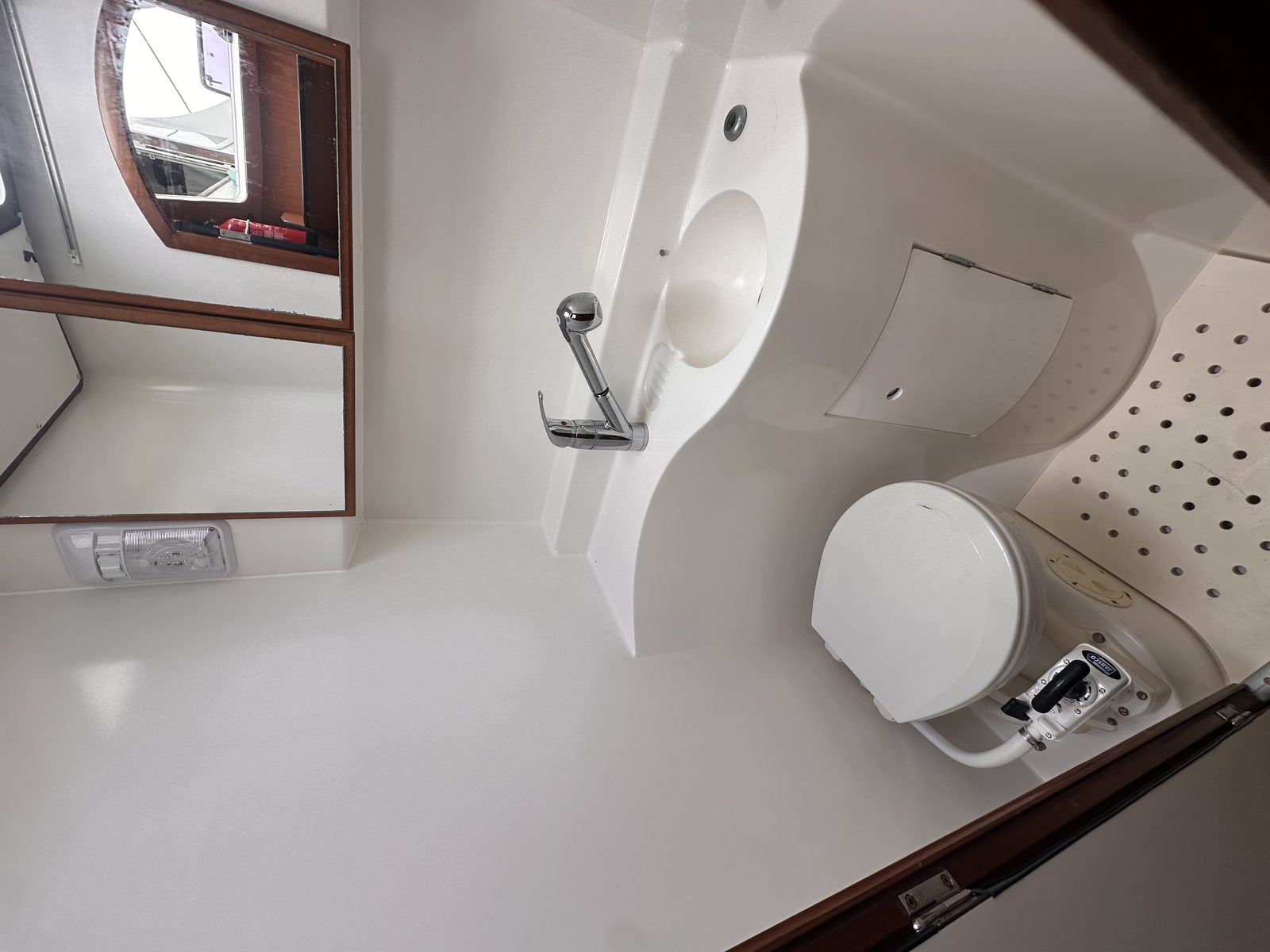Private ensuite bathroom with moulded basin and teak sole