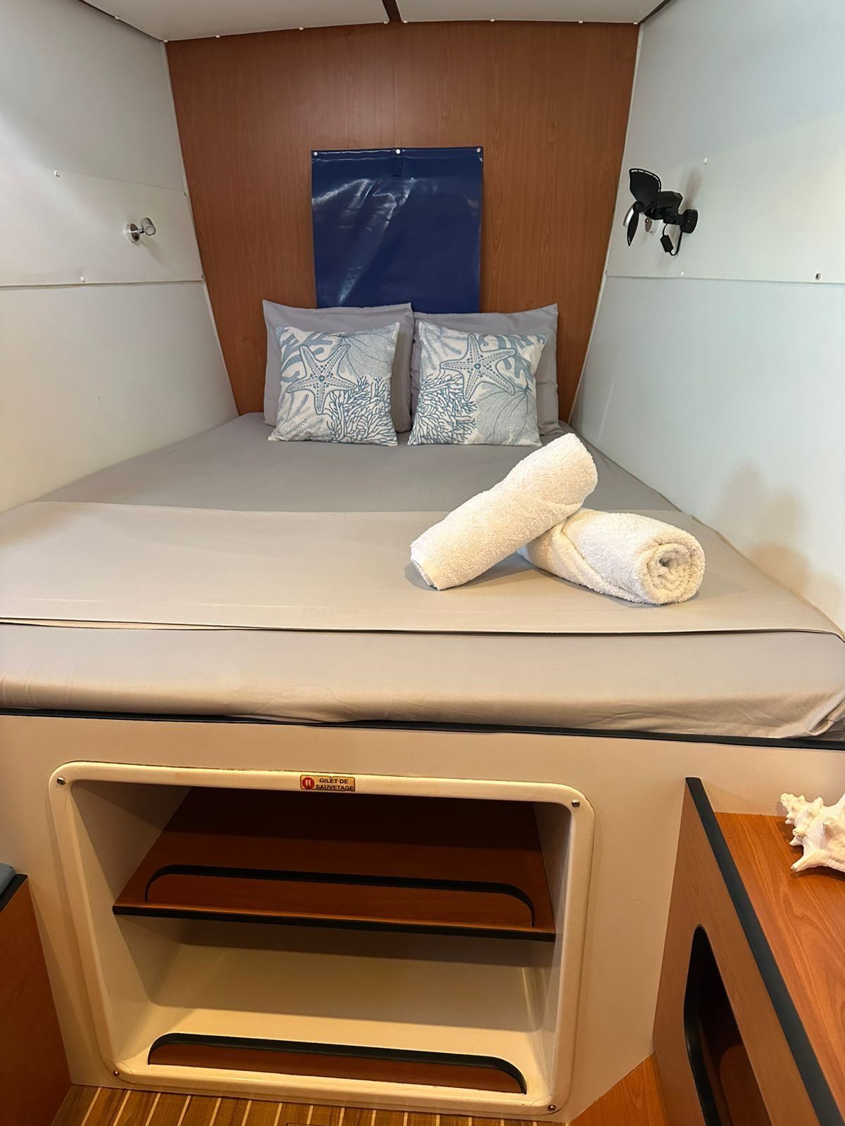 Double cabin with white bedding, rolled towels and cherry joinery