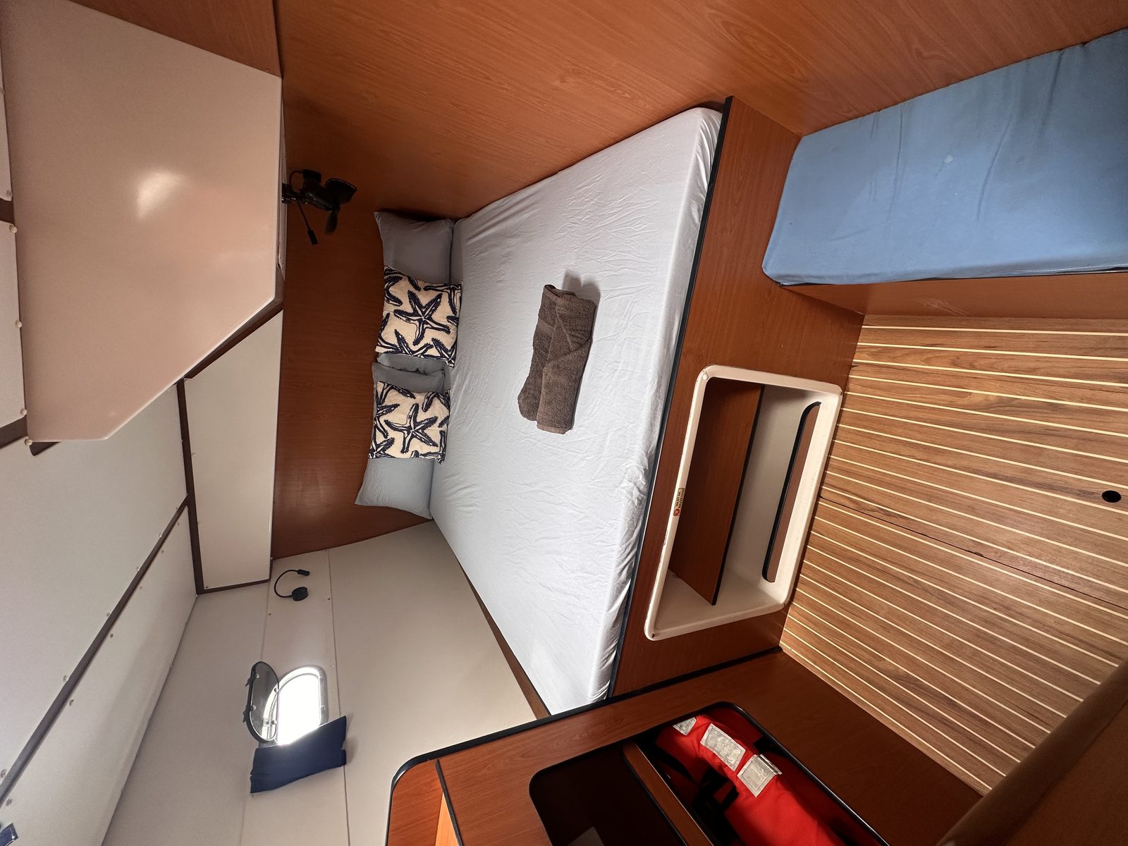 Cabin interior with cherry joinery, cushions and reading lights