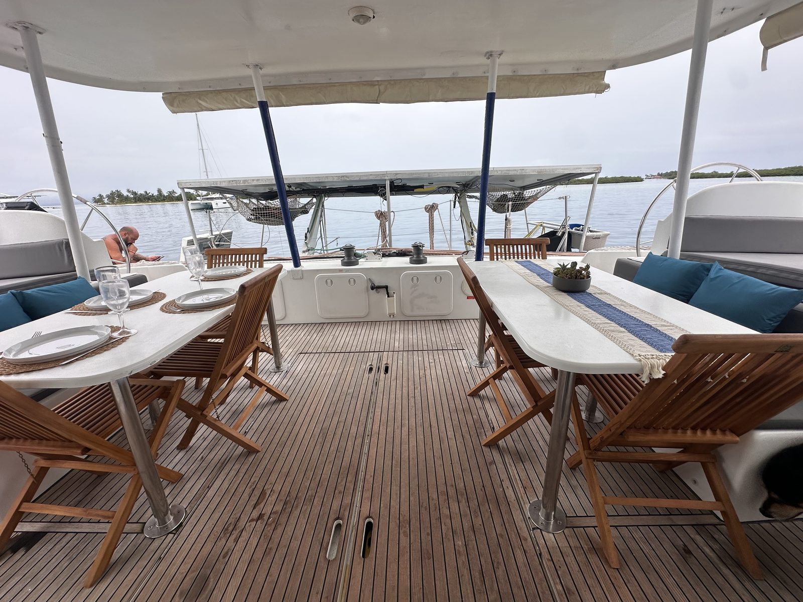Shaded cockpit with teak table, folding chairs and cushioned seating