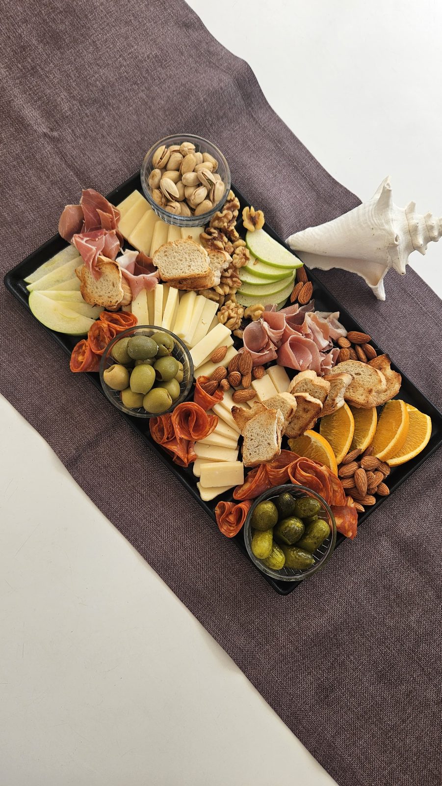 Sharing board of cheese, cured meats, olives and fresh fruit