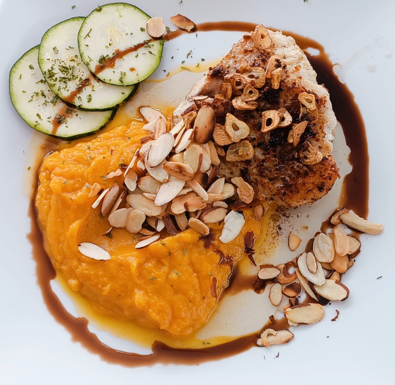 Fish fillet with almonds, pumpkin puree and courgette