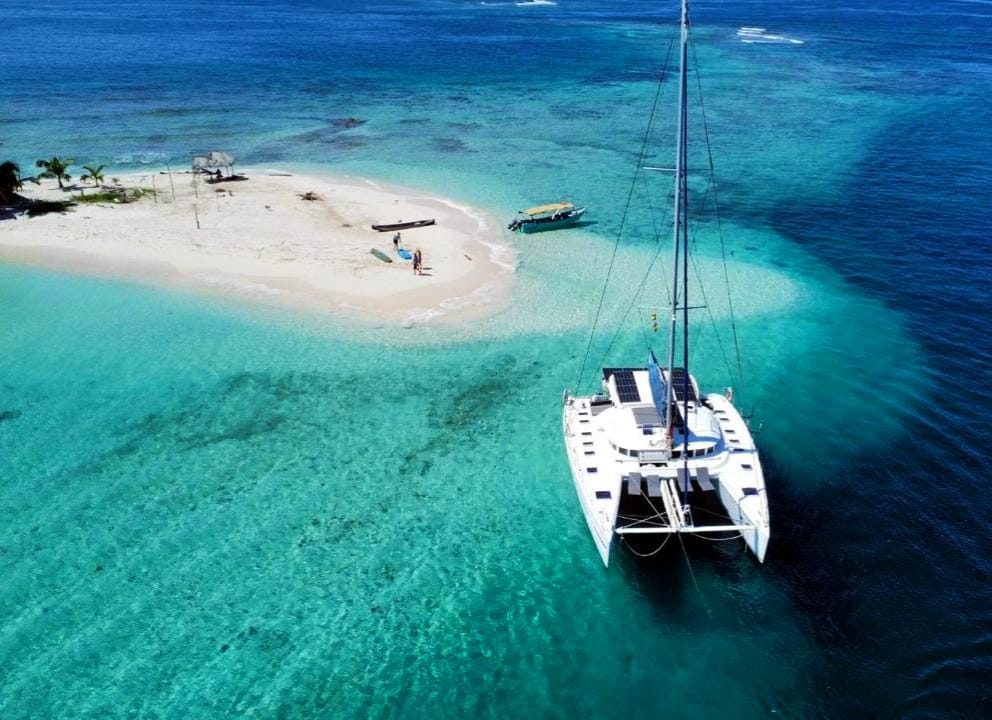 Aerial view of the catamaran anchored off a bright sandbar